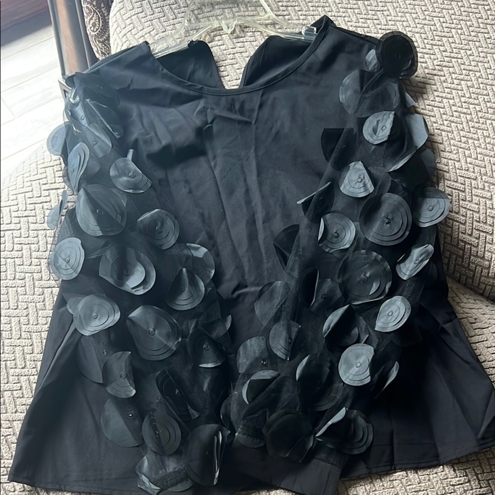 Elegant Black Sleeveless Top with Floral Accents